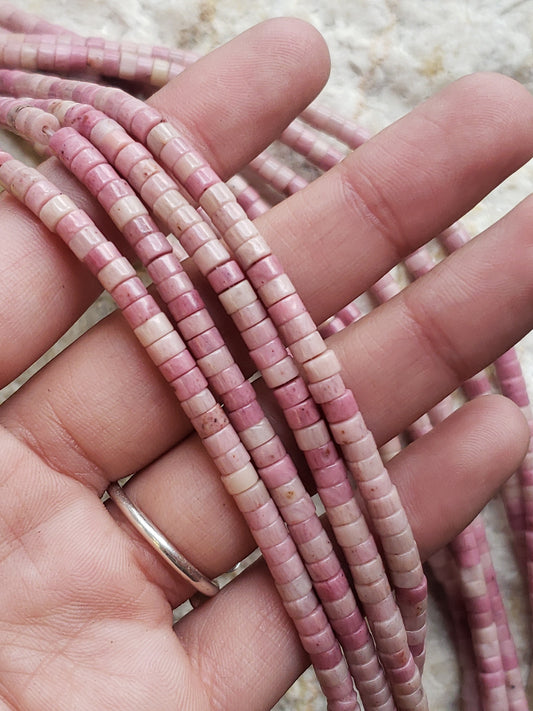 Crafting supplies such as pink rhodonite heishi beads available at wholesale and retail prices, only at our crystal shop in San Diego!