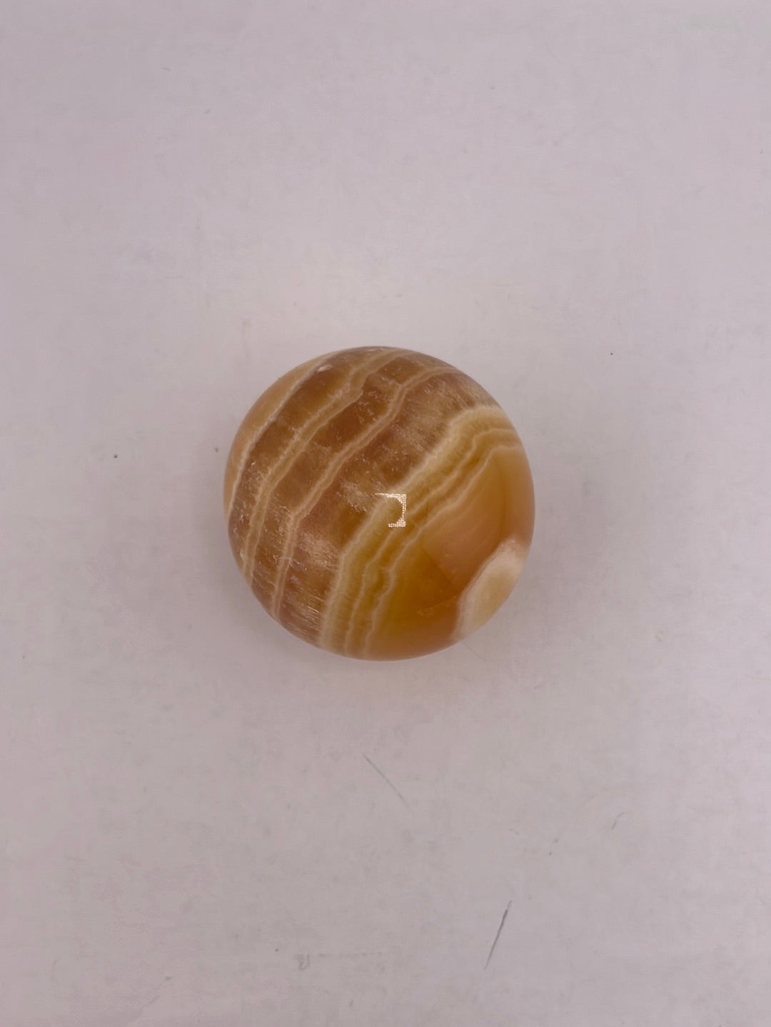 Honey calcite spheres available at wholesale and retail prices, only at our crystal shop in San Diego!