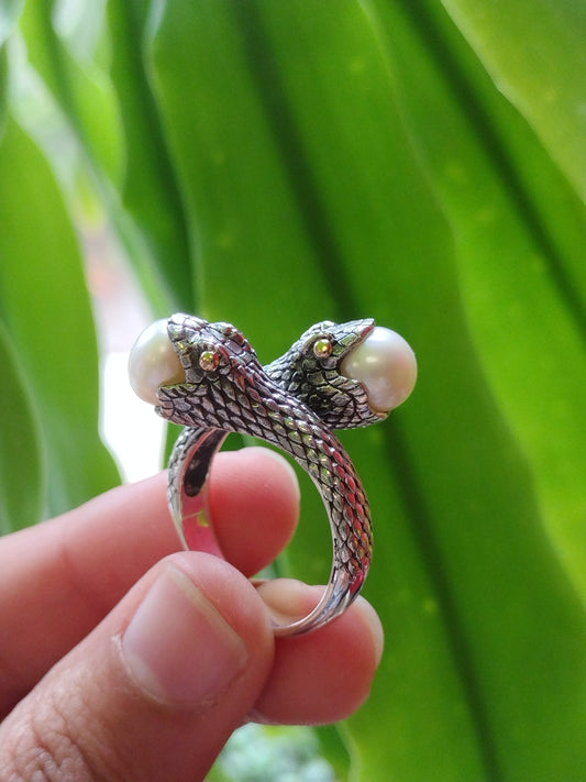 Pearl snake ring with gold eyes and fashioned in Sterling silver